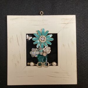 Repurposed vintage jewelry into art. Teal brooch, aurora borealis, flowers art